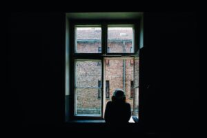 image of person looking out a window