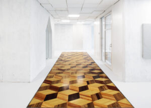 Long geometric floor design in long white hallway 